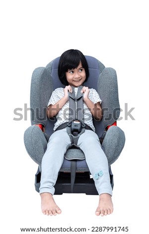 Cute little girl strapped in a car seat isolated on white background