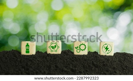 The concept of bioplastic system development Take advantage of the Green Tax Expense tax break. Biodegradable plastic, green background on wooden blocks with icons. Royalty-Free Stock Photo #2287992323