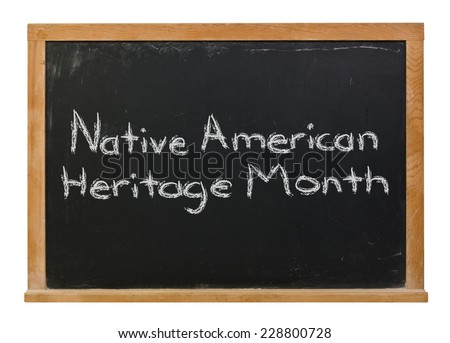 Native American Heritage Month written in white chalk on a black chalkboard isolated on white