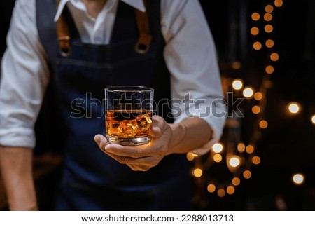 Bartender Serve Whiskey, on wood bar,  Royalty-Free Stock Photo #2288013713