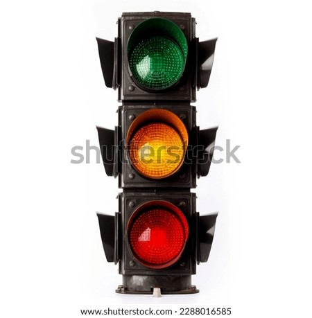 The traffic light is isolated on a white background. All three lights on the traffic light are on. Royalty-Free Stock Photo #2288016585