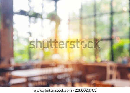 Blurred background cafe coffee shop restaurant in shopping mall with light bokeh business event retail store. Blurry background interior design bar table chair windows decorate indoor space display