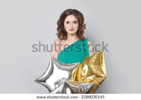 Elegant nice female model woman holding balloon against white studio wall banner background