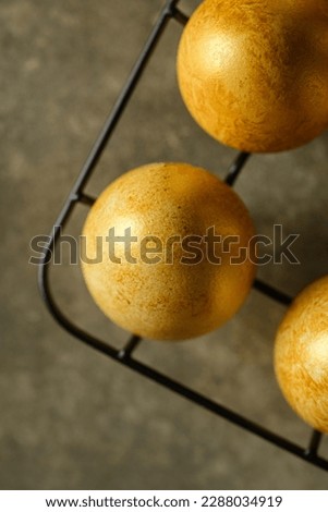 painted golden eggs for easter on green background. High quality photo