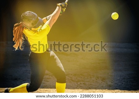 A Baseball Softball Player Is Swinging The Bat With A Soft Light Glare