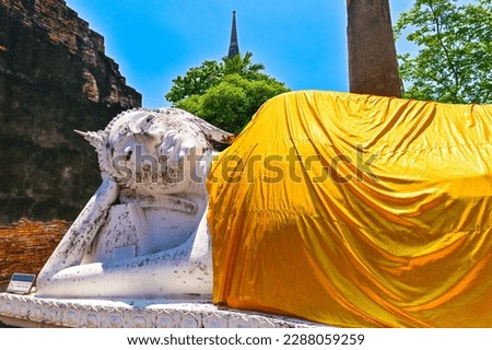 Old reclining buddha statue in Yai chaimongkol temple in Ayuttaya, Landmark of tourists from around the world.