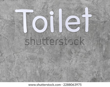 toilet sign with loft concreted wall