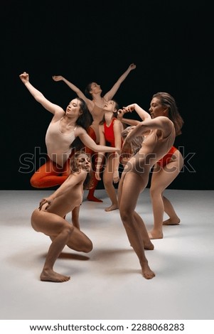 Flow of feelings. Young girls in bodysuits, contemporary, experimental dancers over black background. Concept of art of movement, youth, fashion, artistic lifestyle, flexibility, inspiration Royalty-Free Stock Photo #2288068283