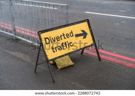 Yellow Diverted traffic sign with arrow on pavement, informational display, transportation and travel concept illustration.