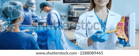 Breast cancer surgery, conceptual image. Surgeons remove malignant breast tumor of female patient lying on operating table in surgery Royalty-Free Stock Photo #2288089465