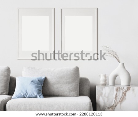 Two blank picture frame mockups on a wall. Portrait orientation. Artwork templates in interior design