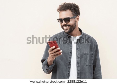 Young handsome man using smart phone, isolated Royalty-Free Stock Photo #2288122611