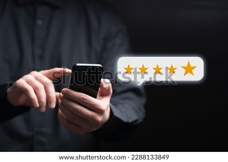 person giving a five star rating online holding a smartphone, customer review concept