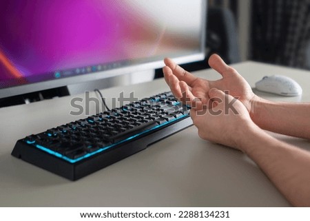 tunnel syndrome, person working in office on computer and holding his hand, feeling pain Royalty-Free Stock Photo #2288134231