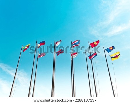 Low Angle View of Waving Flags of ASEAN Countries Against Blue Sky Royalty-Free Stock Photo #2288137137