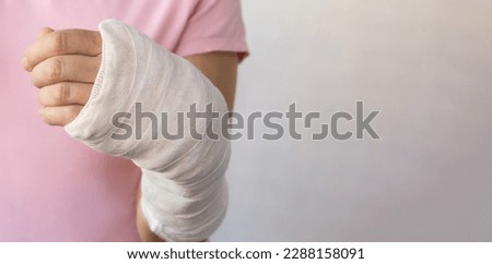 Close-up of a woman's broken arm in a cast. The girl holds a bent arm against the background of a pink t-shirt.
Appropriate treatment in Western medicine. Banner, copy space. Royalty-Free Stock Photo #2288158091