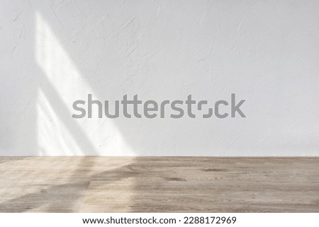 Aesthetic geometric sunlight shadows on a white textured wall and beige wooden floor, empty template for home room interior product, background for branding design showcase, copy space Royalty-Free Stock Photo #2288172969