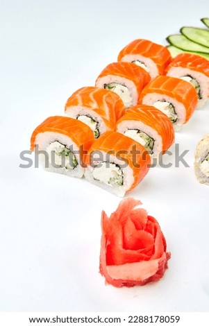 Traditional delicious fresh sushi set Philadelphia roll with salmon, smoked eel and cucumber isolated on white background. Sushi menu. Japanese asian food