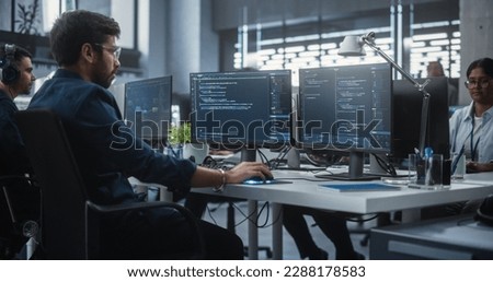 Team of Talented Young Indian Professionals Working in a Technological Research and Development Agency. Computer Screens with Software Code and Technical Neural Network Diagrams Royalty-Free Stock Photo #2288178583