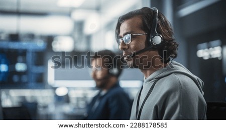 Help Desk Specialist Answering a Call, Providing Technical Support to Client Experiencing Computer Hardware and Software Issues. Indian Male Using a Headset to Have a Conversation with a Tech Team Royalty-Free Stock Photo #2288178585