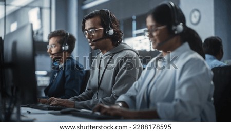 Indian Customer Support Team Using Computers and Talking with Clients Onlinel. Help Desk Employees Responds to Queries, Resolve Problems and Troubleshoot Issues, Implementing Solutions Royalty-Free Stock Photo #2288178595