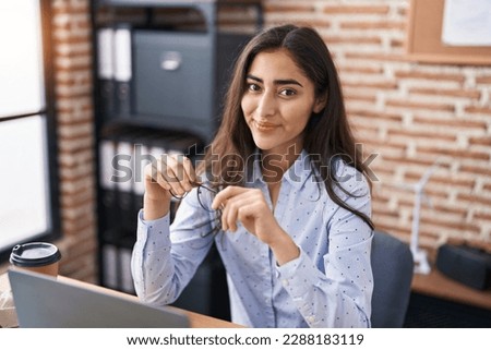 Young hispanic girl business worker using laptop working at office