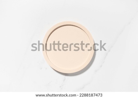 Beauty cosmetics product presentation flat lay mockup scene with beige circle shape on white marble table with copy space. Trendy sunlight,  top view. Studio photography.