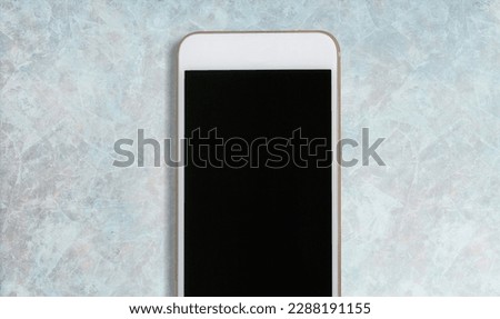 Modern phone with a blank screen on the desk