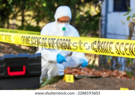 Crime scene investigation. Forensic science specialist working on human remains identification. Royalty-Free Stock Photo #2288193603