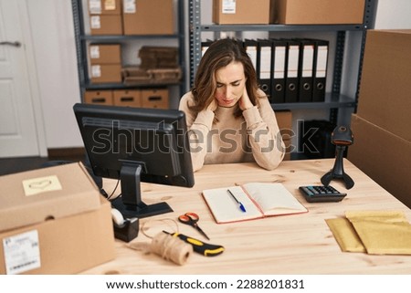 Young woman ecommerce business worker suffering for neck pain at office