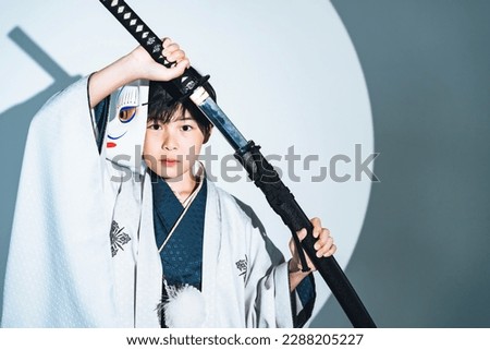 Child samurai wearing kimono. Japanese costume play. Royalty-Free Stock Photo #2288205227
