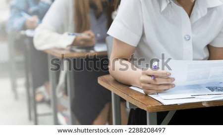 Asian college students concentrate on doing examinations in the classroom. Education stock photo Royalty-Free Stock Photo #2288208497
