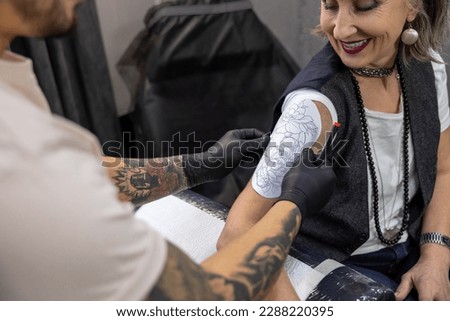 Long-haired woman trying on a skretch for a tattoo