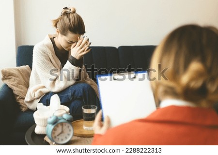 A woman at a psychotherapy session is crying and talking to a psychologist. At an appointment with a psychotherapist. Depression and anxiety. Treatment of anxiety disorder. Mental health.