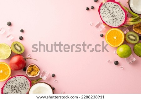Summer in a frame. An eye-catching flat lay of vibrant tropical fruits dragon fruit, kiwi orange lime tomarillo, granodilla and coconut on a pink background and an empty space for promotional content