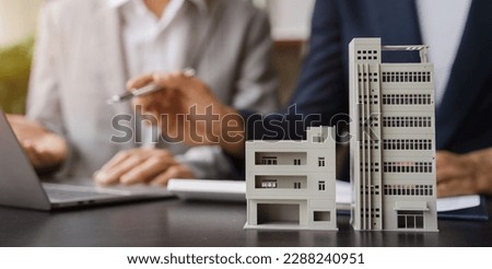 House model with agent asking costumer for contract to buy, get insurance or loan real estate or property. Royalty-Free Stock Photo #2288240951