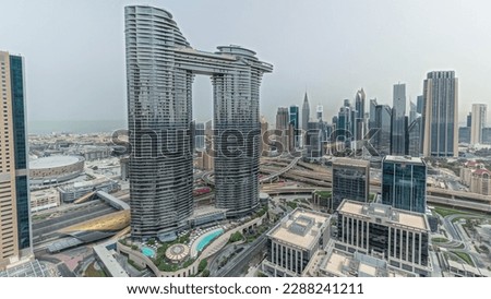 Pnorama showing futuristic Dubai Downtown and finansial district skyline aerial . Many towers and skyscrapers with traffic on streets. City walk district on a background