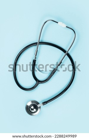 Black stethoscope for doctor diagnostic coronavirus disease, medical tool for health on blue background with copy space. Royalty-Free Stock Photo #2288249989