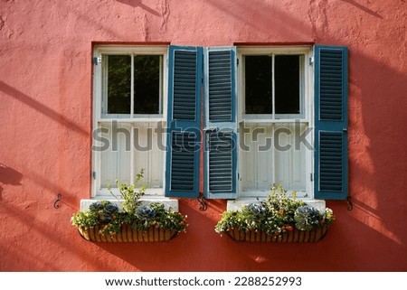 Window with three blue shutters