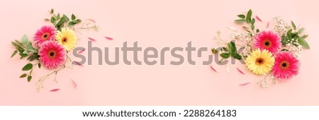 Top view image of beautiful flowers composition over pastel pink background