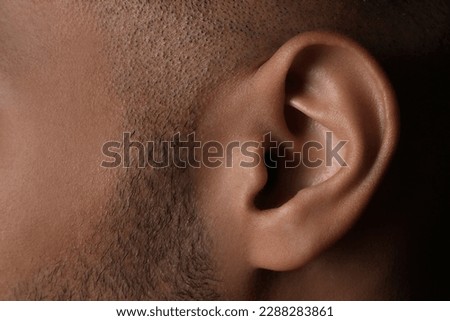 Closeup view of man, focus on ear Royalty-Free Stock Photo #2288283861