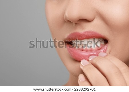 Woman showing healthy gums on grey background, closeup. Space for text Royalty-Free Stock Photo #2288292701