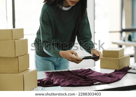 Female owner taking pictures of online product.