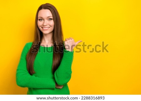 Portrait of lovely positive lady beaming smile direct thumb finger empty space isolated on yellow color background