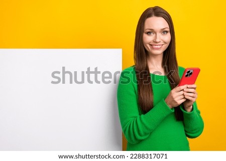 Portrait of pretty person hold use smart phone empty space placard isolated on yellow color background