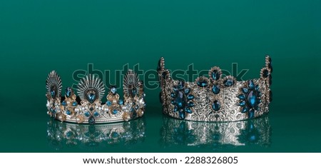 crown with precious stones isolated on green background