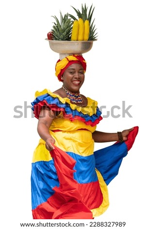 Happy smiling Palenquera fresh fruit street vendor of Cartagena, Colombia, dancing, isolated on white background. Afro-Colombian woman in traditional clothing, Colombian culture and lifestyle. Royalty-Free Stock Photo #2288327989