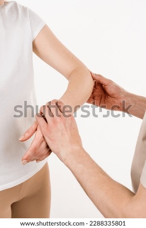 Tennis elbow close-up. Lateral epicondylitis is painful condition of the elbow joint caused by overuse. Orthopedist traumatologist examines elbow joint with pain and prescribes treatment for patient Royalty-Free Stock Photo #2288335801