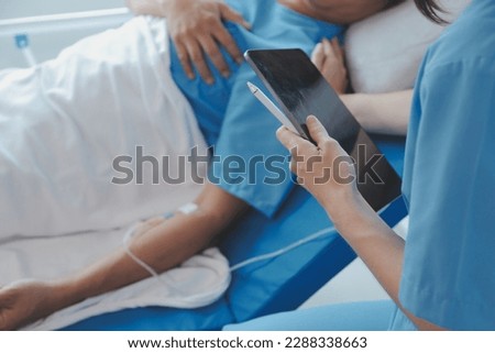 Women Asian doctors hold the patient hand and encourage and provide medical advice While checking the patient health in bed. Concept of Care and compassion, antenatal care, Threatened abortion