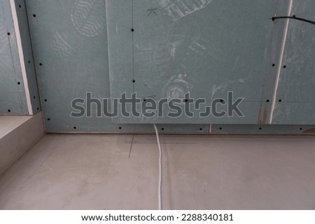 Construction worker, making walls from gypsum plasterboard or drywall